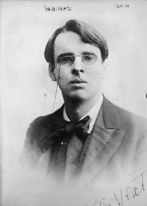 the Irish poet Yeats is a young man wearing glasses and a bow tie