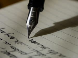 pen and paper writer writing fiction